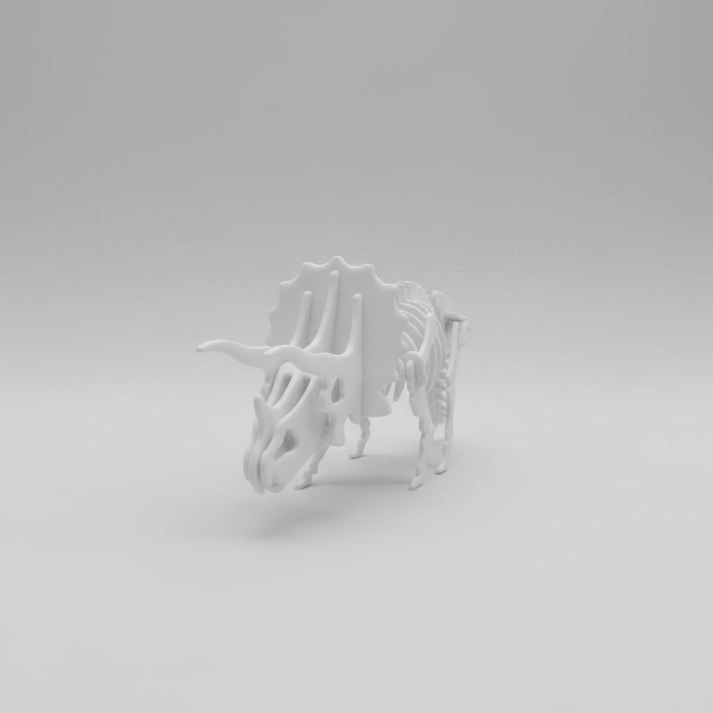 A white 3D-printed articulated skeleton model of a Triceratops, shown on a neutral gray gradient background.