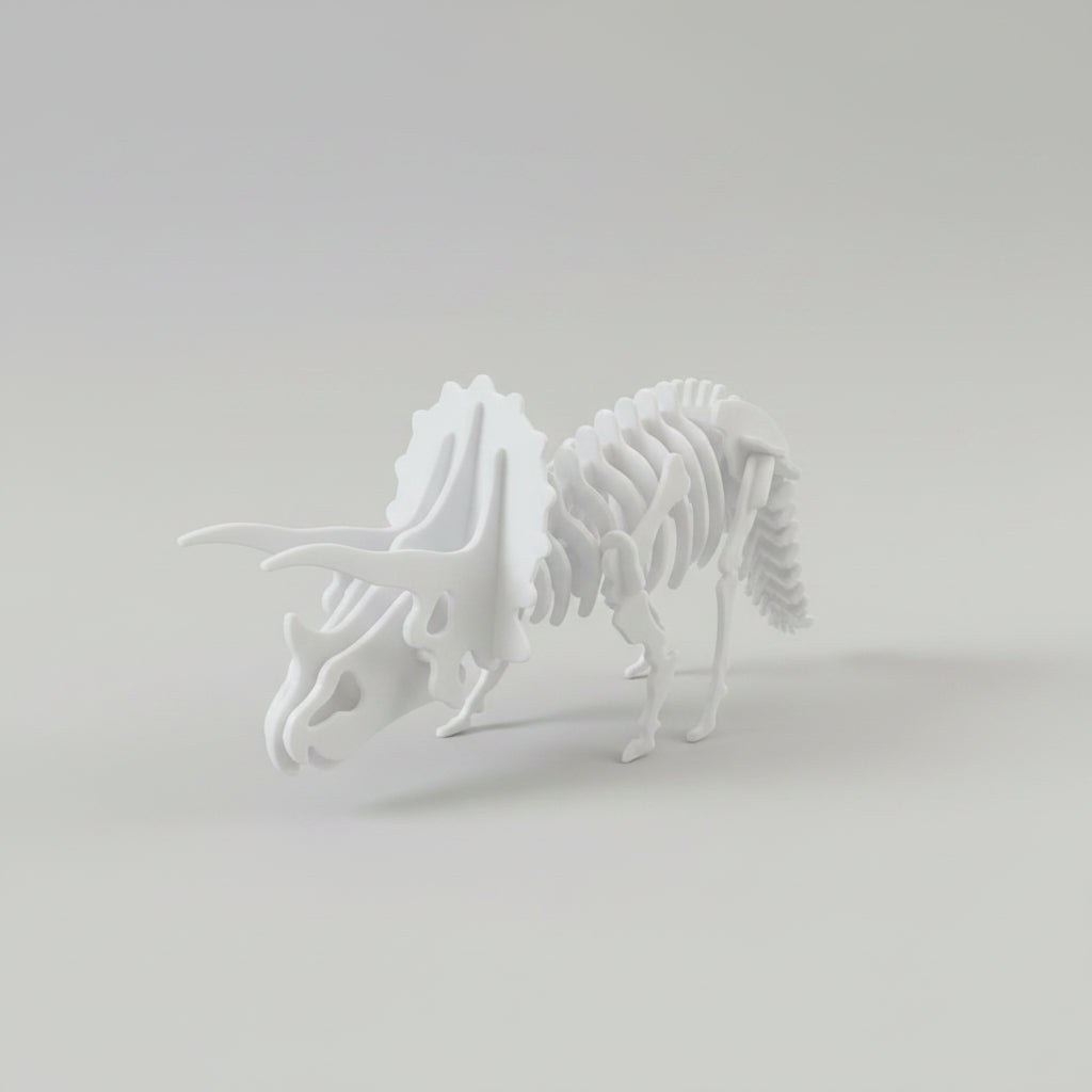 A white 3D puzzle model of a Triceratops dinosaur skeleton, shown standing on a neutral light gray background.