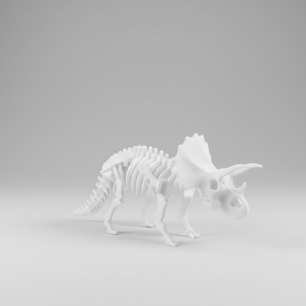 A white 3D-printed model of a Triceratops dinosaur skeleton, shown from a side profile against a neutral gray studio background.