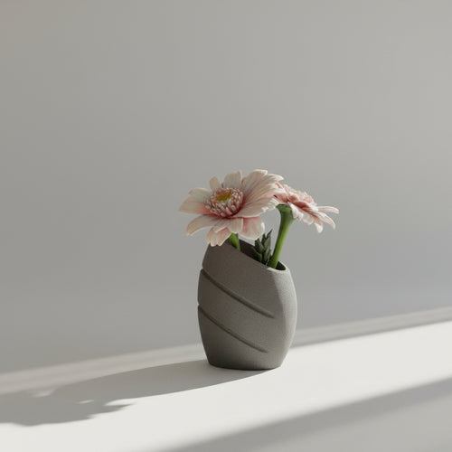 Gray textured vase with a pink flower on a light gray background